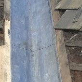 Lead flashing showing old tiles and new carpentry